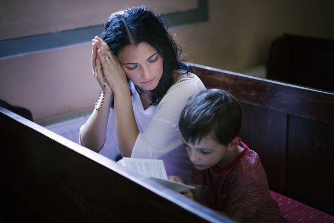 Woman with her son praying